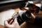 Man hands adjusts the lens retro camera on a wooden table