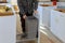 Man hands assembling furniture garbage bin in the kitchen