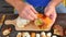 Man hands carefully cleaning wild mushroom with kitchen knife. Hands take mushroom and remove clay or roots from stem