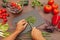 Man hands chop fresh parsley on rustic wooden table