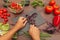 Man hands chopped fresh basil on wooden table