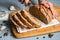 Man hands cut with knife piece of rye bread