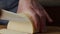 Man hands cutting piece of cheese on kitchen board close up