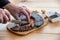 Man Hands cutting Slices of Special Pirot horseshoe ironed sausage - Peglana Pirotska kobasica