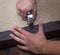 Man hands fastening leather to the particle board using stapler