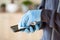 Man hands in gloves disinfecting smartphone, eliminating germs coronavirus bacteria