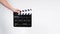 A man with hands is holding black Clapperboard or movie slate. it use in video production ,film, cinema industry.It is white