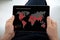 Man hands holding computer tablet live map global spread virus