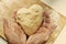 Man hands holding homemade heart shaped pastry