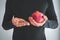 Man hands holding iron supplements and fresh pomegranates to cure anemia