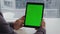 Man hands holding tablet chromakey city view table. Student reading mockup pad