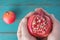 Man hands holds one Pomegranate Fruit with seeds