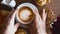 Man Hands Move Cup of Coffee on Wooden Table with Bakery Pastry Selection