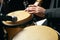 Man hands playing music at djembe drums