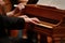 Man hands playing on a old piano at Classical concert