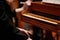 Man hands playing on a old piano at Classical concert