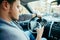 Man hands on steering wheel using phone as navigator