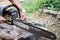 man hands use a rasp to sharpen the blade chainsaw