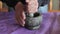 Man hands using stone mortar and pestle to grind herbs