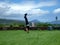 Man handstands in grass field on top of Kaimuki