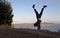 Man Handstands in on hill in front of the Golden Gate Bridge