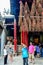 Man hanging foreigner tourist\'s incense coils at Thien Hau Pagoda, Cho Lon, Saigon, Vietnam