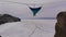 Man hanging in hammock above by ice of frozen lake Baikal.