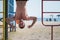 Man hanging upside down at kids playground