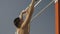 Man hangs on horizontal bar