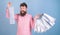 Man with happy face and trendy beard holding shopping bags. Shopaholic spending all salary on clothes. Bearded man in