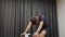Man hard pedaling on cycle smart trainer indoor. Close up of young fit male cycling on bicycle and unzipping jersey. Professional