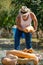 Man harvests big pumpkin from patch.