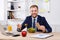 Man has healthy business lunch in modern office interior