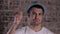 Man with hat happy portrait smiling on brick background