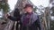 Man in hat by tree in forest, enjoying winter recreation