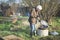 Man having a bonfire at an allotment or community garden vegetable plot to dispose of garden waste