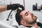 Man having his hair washed in hairdressing salon