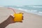 Man having an orange drink on the beach