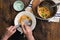 Man is having supper Italian pasta on rustic wooden table