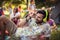 Man in headphones holding beer bottle at campsite