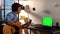 Man in headphones playing guitar at home