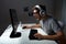 Man in headset playing computer video game at home