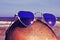 man with heart-shaped sunglasses on the beach, with a retro effect