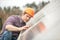 Man in helmet checking surface of object