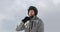 Man with helmet closing up soft shell jacket preparing for skiing.Mountaineering ski activity. Skier people winter sport