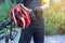 Man with helmet glove for safety riding a bicycle at countryside