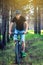 Man in a helmet riding on a mountain bike in the woods among the trees. Cyclist in motion. Active and healthy lifestyle