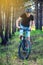 Man in a helmet riding on a mountain bike in the woods among the trees. Cyclist in motion. Active and healthy lifestyle