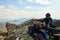 Man in helmet sitting on ATV quad bike in mountains