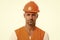 Man in helmet. wear construction helmet on building site. Builders dressed in protective vest and helmet. Construction